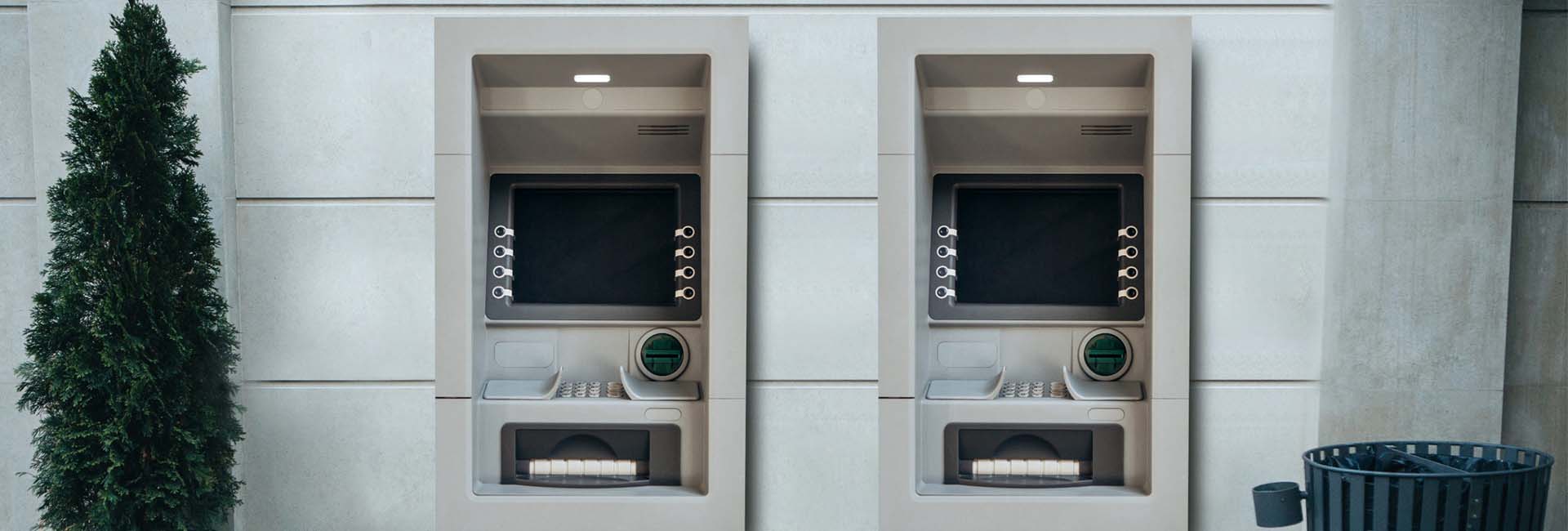 Two wall-mounted outdoor ATMs at a bank location