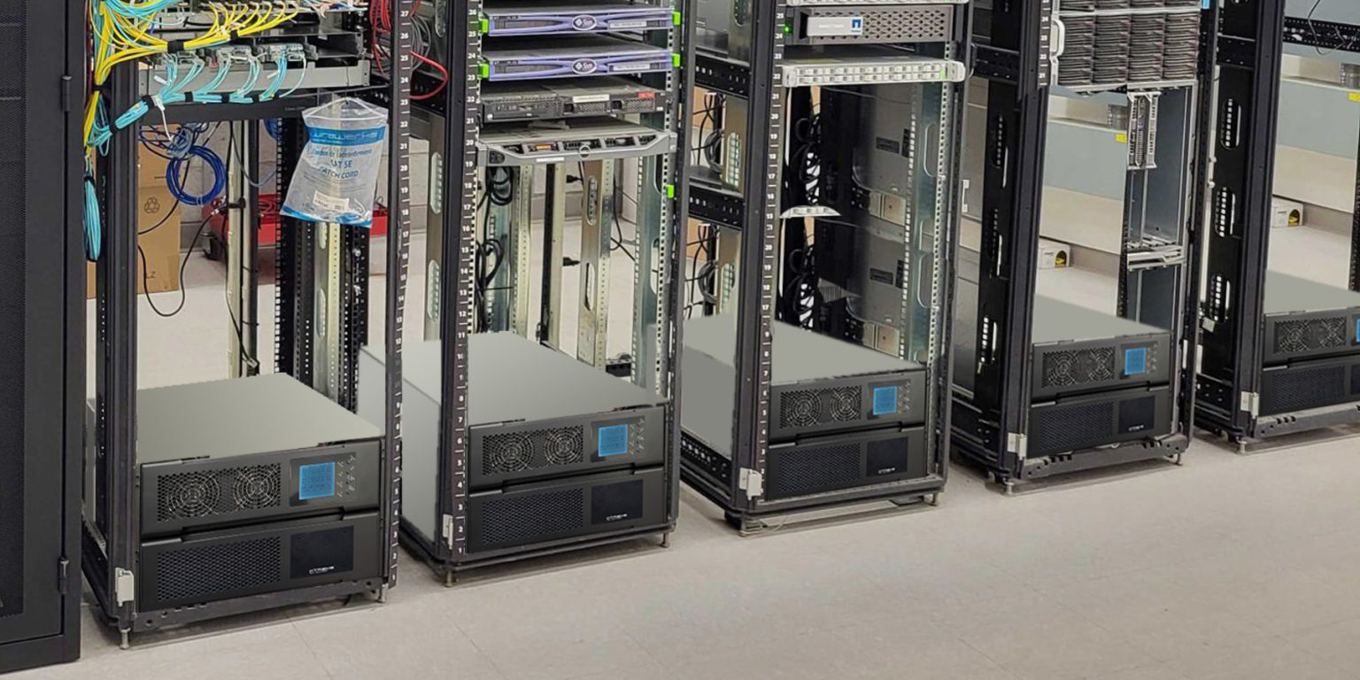 M90C-2S TAA-compliant modular three-phase UPS systems at the base of production racks in an enterprise data center — deployed across VA Medical Centers and federal facilities