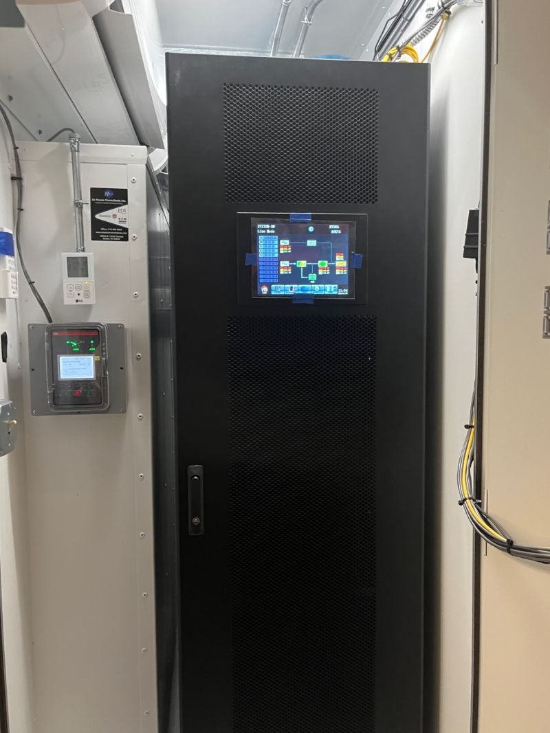 M90U-80 UPS deployed in outdoor shipping container enclosure — HYDRA POD — showing exterior access panel and weatherproof construction