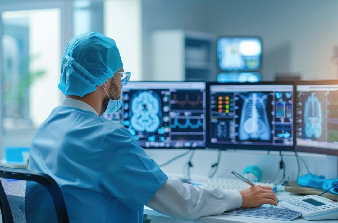 Radiologist reviewing CT, MRI and X-ray studies on diagnostic imaging displays