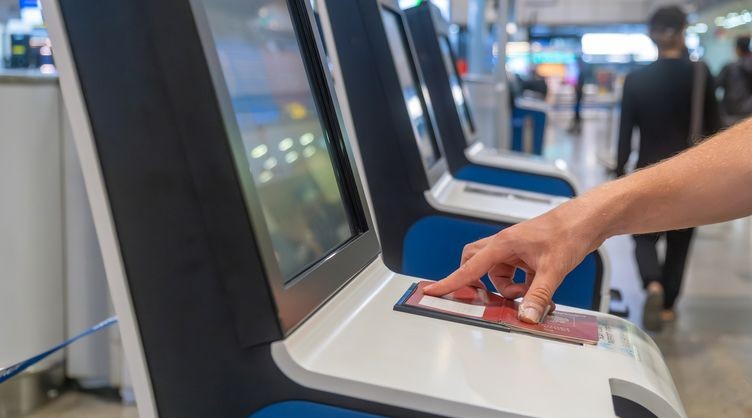 Traveler using a self-service passport gate