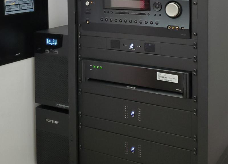 Xtreme Power T91 tower UPS alongside full Savant home AV rack — real residential smart home installation with automation processors and audio video equipment