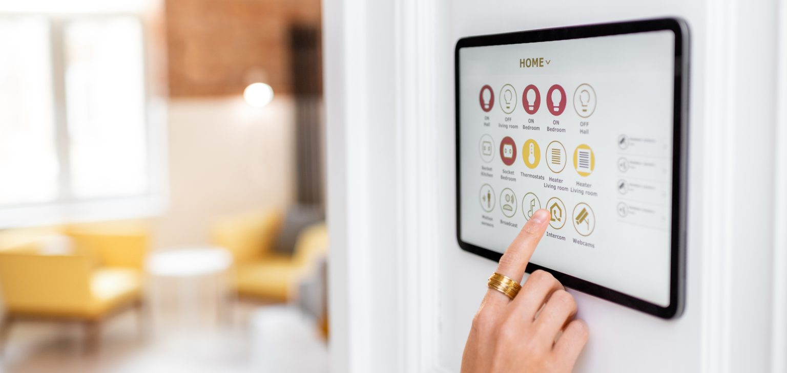Smart home touchscreen control panel being operated in residential living space — home automation system requiring continuous power protection