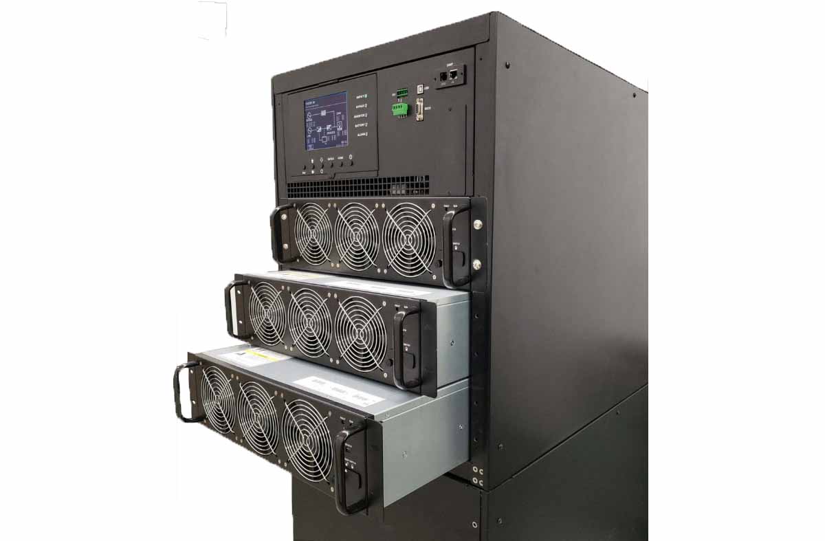 M90U UPS installed in an electrical room with its three hot-swappable power modules partially withdrawn from the enclosure, each module showing its three-fan array and pull handles, above the integrated control panel with graphic LCD and SNMP/USB/RS-232 communications