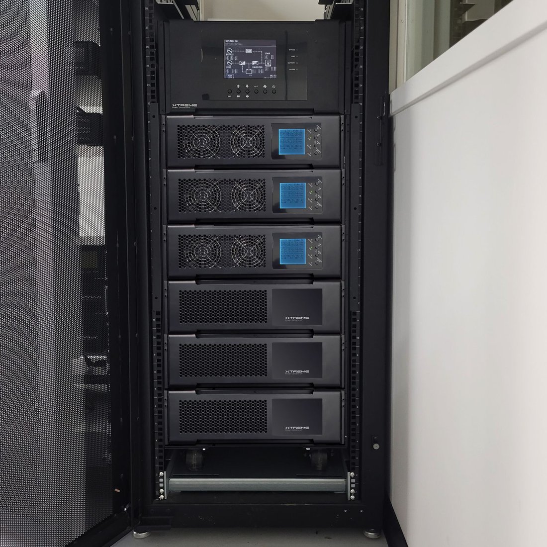 M90S modular UPS rack-mounted with three power modules and three battery modules replacing an APC Symmetra LX